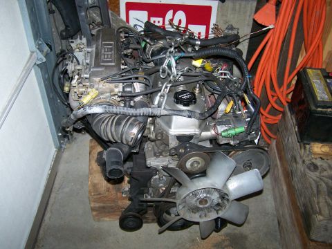 1988 Suzuki Samurai - This engine assembly is mounted on a wooden pallet, ready for installation or repair.