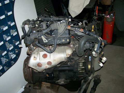 1988 Suzuki Samurai - Engine assembly with various hoses and electrical connectors visible.