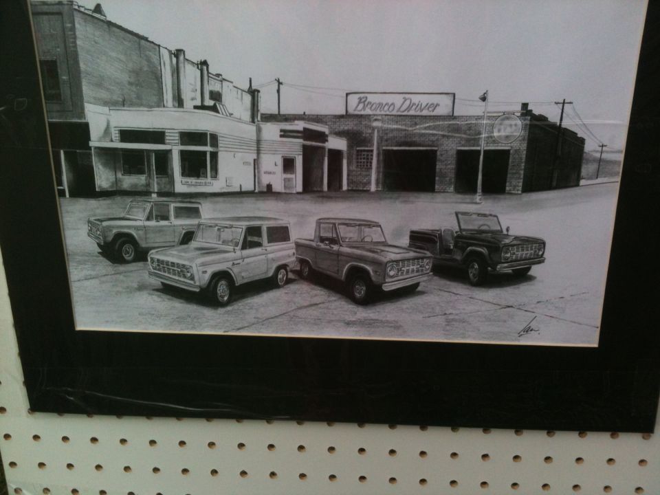 Pencil drawing of four Ford Broncos from different eras parked in front of a building with a 'Bronco Driver' sign