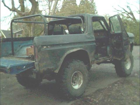 1978 Ford Bronco - This vehicle appears to be a Ford Bronco, possibly from the late 1970s or early 1980s, with a custom roll cage.