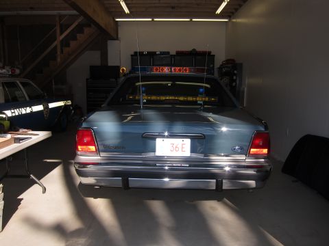 1991 Ford LTD Crown Victoria - Rear view of a 1991 Ford Crown Victoria LTD police car parked in a garage.