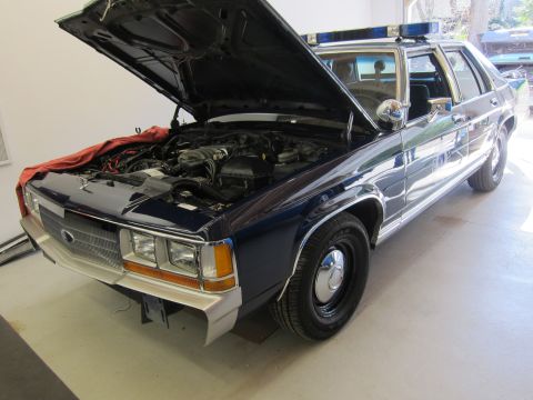 1991 Ford LTD Crown Victoria - Police car with hood open, revealing the engine compartment.