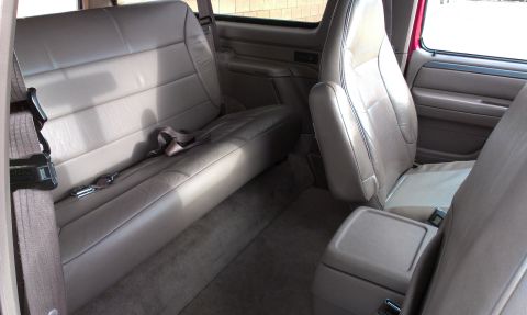 1994 Ford Bronco - The interior of a 1994 Ford Bronco features tan leather seats and a center console.