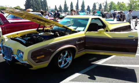 1994 Ford Bronco - A classic Ford Ranchero with its distinctive wood grain side paneling is displayed with the hood and driver's door open.