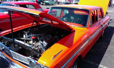 1994 Ford Bronco - A classic car with its hood open, revealing the engine, sits on display.