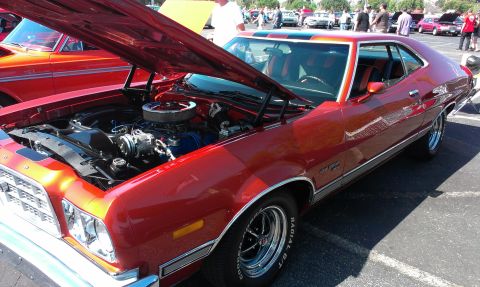 1994 Ford Bronco - A red 1972 Ford Gran Torino is displayed with its hood open at an outdoor car show.