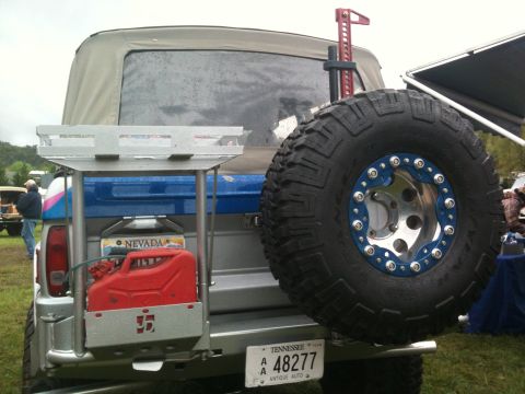 1992 Ford Bronco - This modified Ford Bronco features a high-lift jack and a large spare tire mounted on the rear.