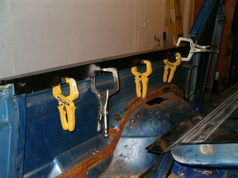 1990 Ford Bronco - Repairing the interior of a vehicle, with clamps holding a panel in place.