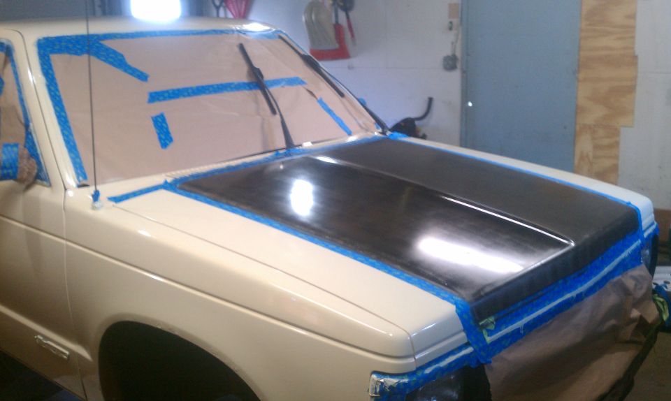 Cream 1991 Chevrolet S10 pickup truck with hood taped off for painting