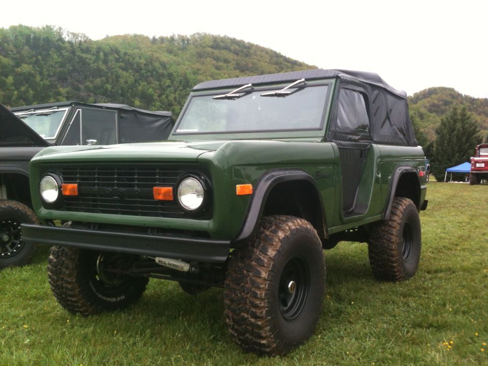 Green SUV with soft top and large tires