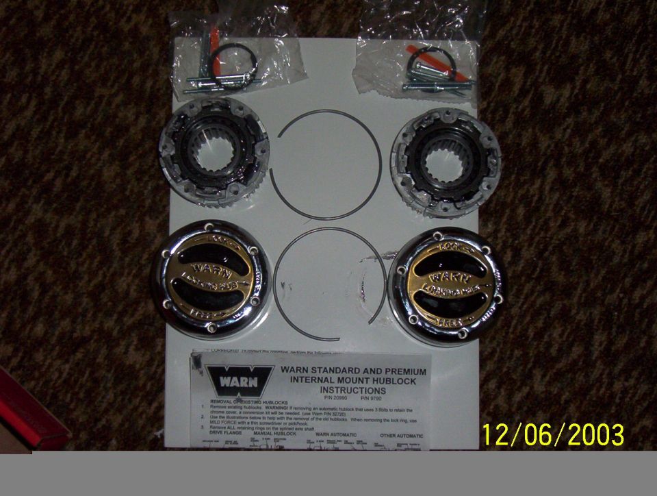 Warn premium manual locking hub kit with chrome dials, splined bodies, snap rings and instruction sheet