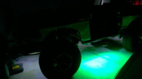 1994 Ford Bronco - A 1994 Ford Bronco is shown with green underglow lighting illuminating the ground.