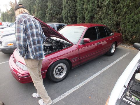 2003 Ford Crown Victoria - Lowered maroon Crown Victoria on polished alloys, hood raised, a person standing at the front.