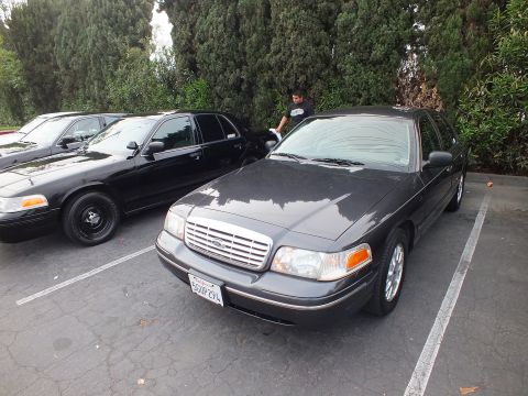 2003 Ford Crown Victoria - Gray Ford Crown Victoria parked next to a black example on steel wheels at a car meet.