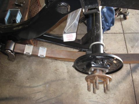 1963 Ford Galaxie - Close-up of a vehicle's rear axle and leaf spring assembly during restoration.