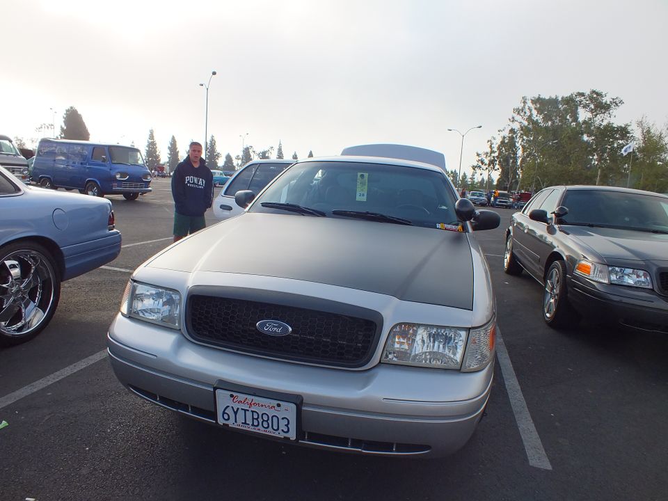 Silver Ford sedan with blacked-out grille and California 6YIB803 plate, man behind