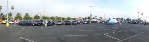 2003 Ford Crown Victoria - wide panoramic view of a large parking-lot car meet with rows of parked cars and a roller coaster on the horizon.