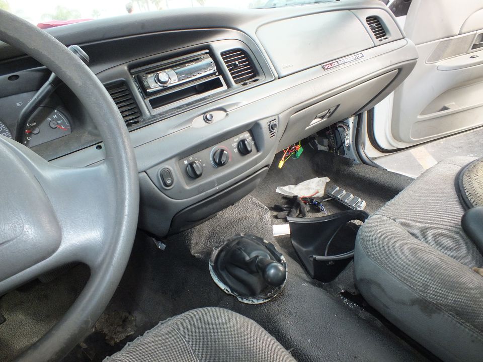 Crown Victoria interior with aftermarket stereo and shifter hole in floor