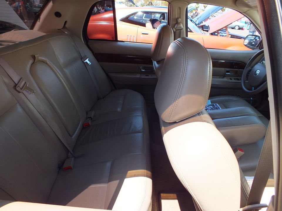 Tan leather rear bench and front seats inside a full-size sedan