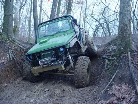 1992 Ford Bronco - A Suzuki Samurai navigates a challenging, muddy off-road course.