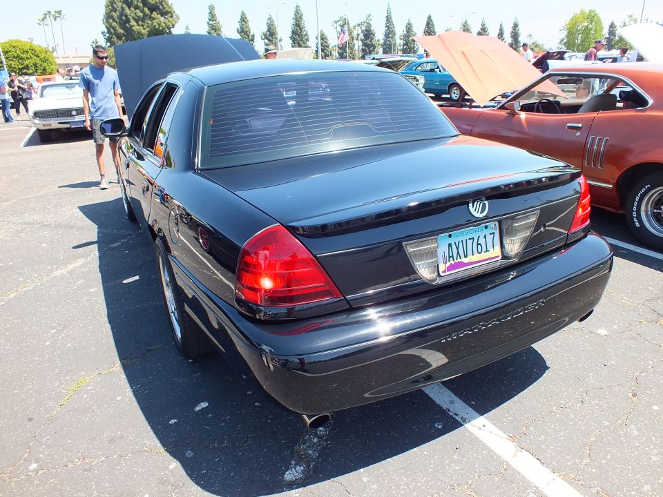 Rear view of a black Mercury sedan with license plate at a car show