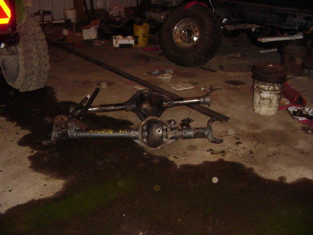Two differential axles, one with yellow text reading "BRONCO 74"