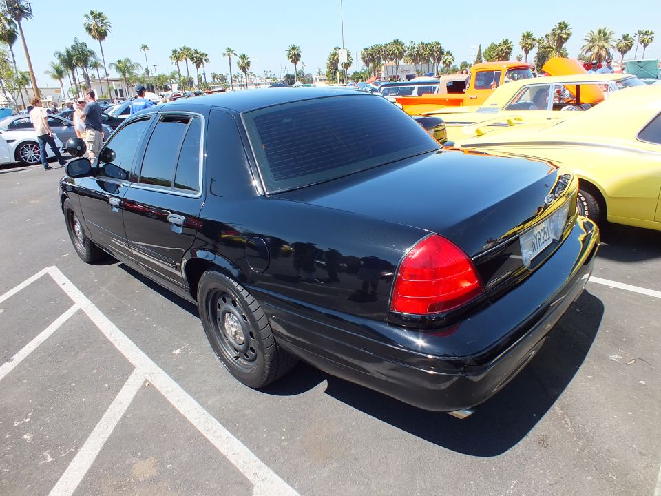 Black Ford sedan rear three-quarter view at a car show
