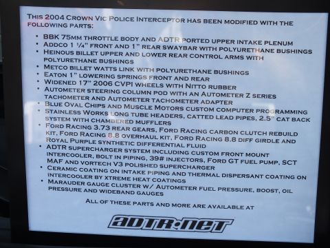 2003 Ford Crown Victoria - Backlit car-show display sign listing aftermarket parts and modifications on a 2004 Crown Vic, not a technical document.