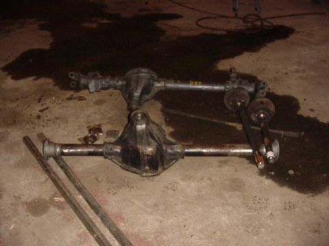 1992 Ford Bronco - Two vehicle rear axles are shown resting on a concrete floor, possibly in a garage or workshop.