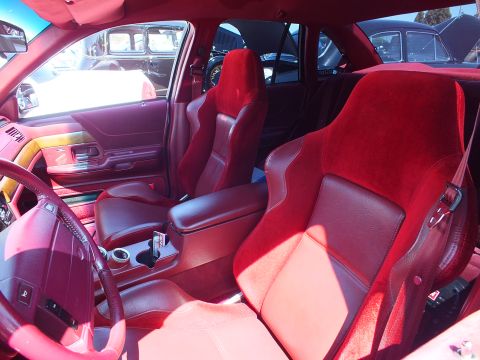 2003 Ford Crown Victoria - Interior of a customized car with red suede sport seats, red door panels and a wood-rimmed steering wheel.
