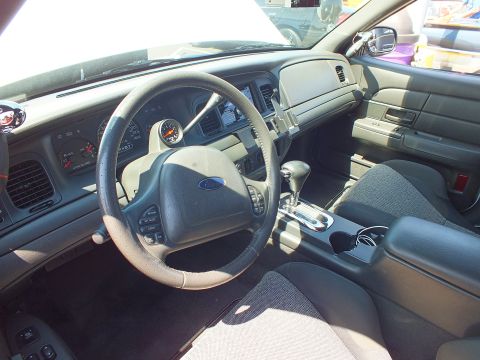 Ford sedan dashboard and steering wheel with column gauge, automatic shifter and gray seats