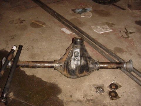 1992 Ford Bronco - A rear axle differential assembly, identified by the "602" marking on its housing, lies on a concrete floor.