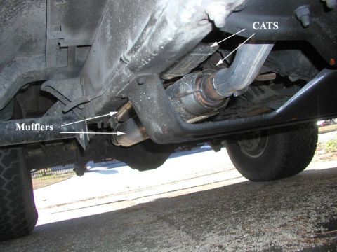1988 Ford Bronco - Underbody shot of a dual exhaust system on a lifted truck, with white arrows and text labels pointing out the two catalytic converters and…