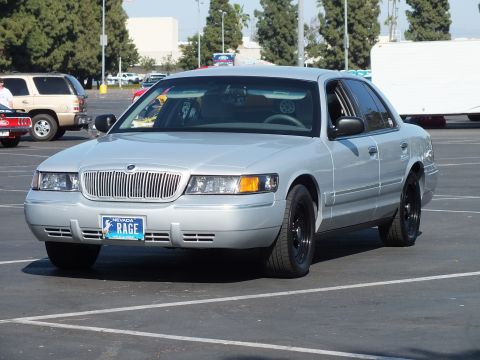 Silver Mercury Grand Marquis sedan with black wheels, front three-quarter