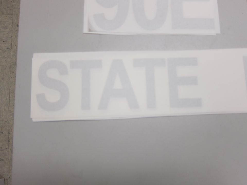White decal with gray text reading STATE