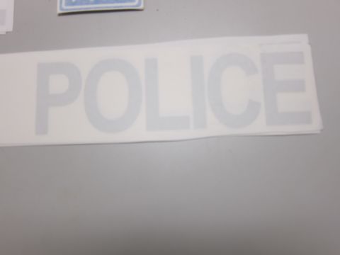 1991 Ford LTD Crown Victoria - A decal with the word POLICE is shown against a gray background.