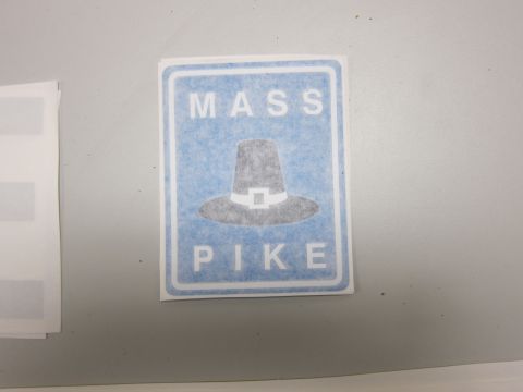 1991 Ford LTD Crown Victoria - A sign graphic depicting a pilgrim hat with the words MASS PIKE above and below it.