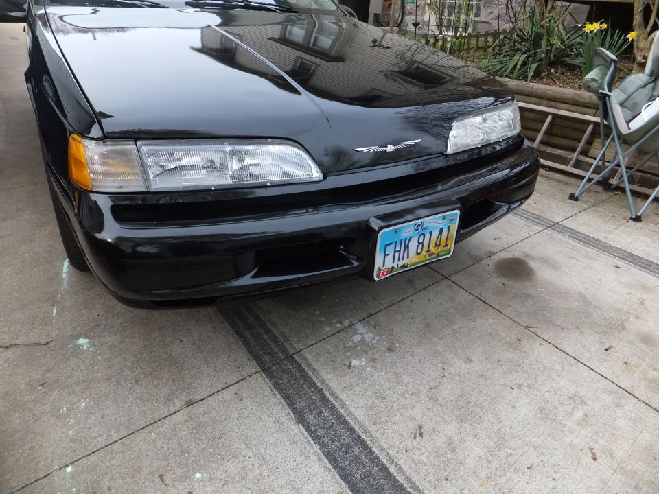 Black Ford Thunderbird front end with a license plate that reads FHK 8141
