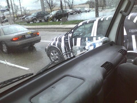 2003 Ford Crown Victoria - A car is seen with a distinctive black and white zebra stripe camouflage pattern, possibly for testing or advertising.