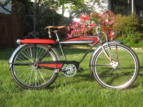 1994 Ford Bronco - Side view of a vintage J.C. Higgins bicycle parked on grass with pink flowers in the background.