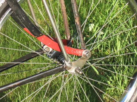 1994 Ford Bronco - Close-up view of a bicycle's front fork and wheel assembly, showing spokes and painted frame elements.