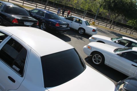 1992 Ford Crown Victoria - Several Ford Crown Victorias are parked in a lot, with one white model in the foreground.