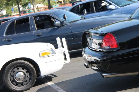 1992 Ford Crown Victoria - Multiple Ford Crown Victorias are parked together, showing their rear and front ends.