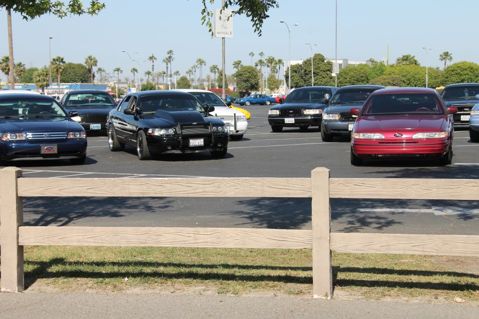 Red 1992 Ford Crown Victoria parked in a lot with other cars