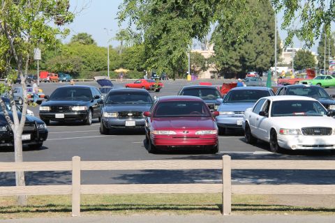 1992 Ford Crown Victoria - Several cars are parked in a lot, including a white 1992 Ford Crown Victoria in the foreground.