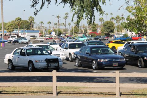1992 Ford Crown Victoria - A dark blue 2006 Ford Crown Victoria is parked in a lot filled with various vehicles.