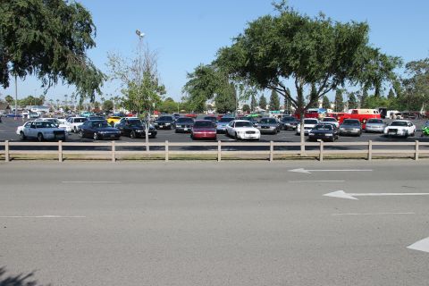 1992 Ford Crown Victoria - A parking lot filled with various cars under a clear blue sky.