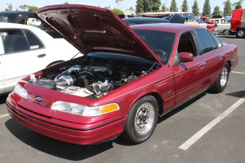 1992 Ford Crown Victoria - Red 1992 Ford Crown Victoria with its hood open, displaying the engine and turbo setup.