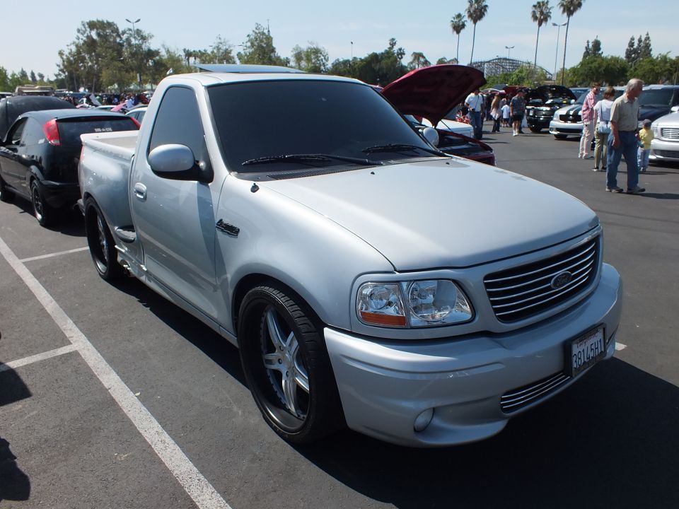 Front three-quarter of a silver Ford F-150 Lightning pickup with billet grille