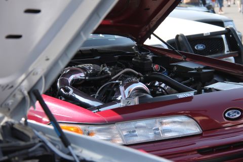 1992 Ford Crown Victoria - The engine bay of a 1992 Ford Crown Victoria is displayed with custom modifications, including a turbocharger.